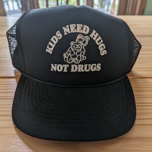 Black Trucker Hat with 'Kids Need Hugs Not Drugs' Design